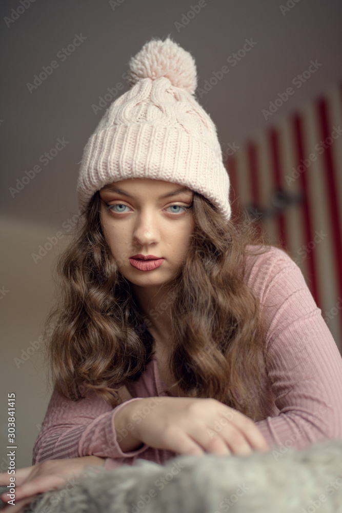 Portrait of cute young woman in pink bodysuit and winter lies in bed waiting for christmas holidays. Peaceful, calm, sad atmosphere. Portrait of cute young woman in pink bodysuit and winter lies in bed waiting for christmas holidays. Peaceful, calm, sad atmosphere.