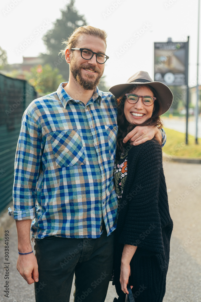 Fototapeta premium Young beautiful happy couple outdoor posing hugging