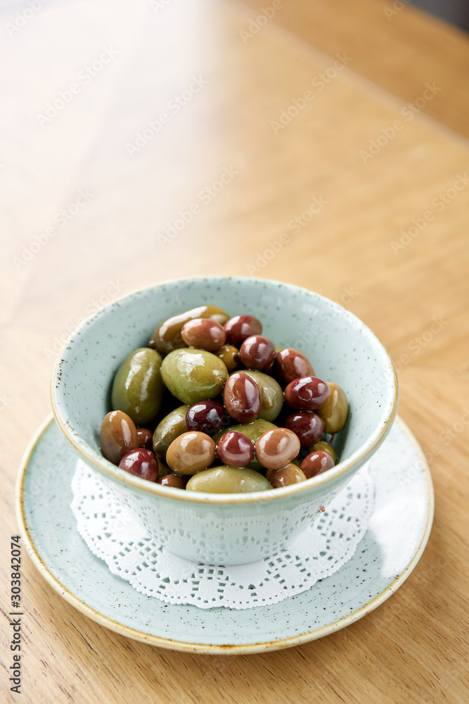 Olives in homemade marinade with herbs. Bowl black and green olives. Olives in homemade marinade with herbs. Bowl black and green olives.
