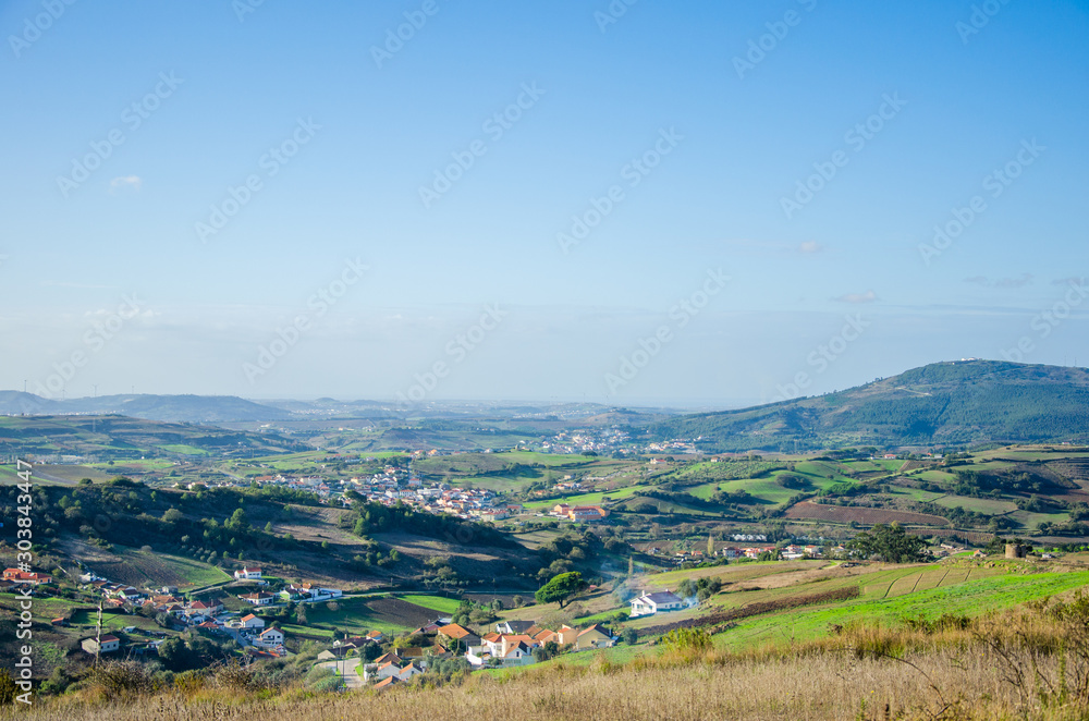 Beautiful view of the fields and city in Portugal, panorama. Sky with clouds. Place for text.