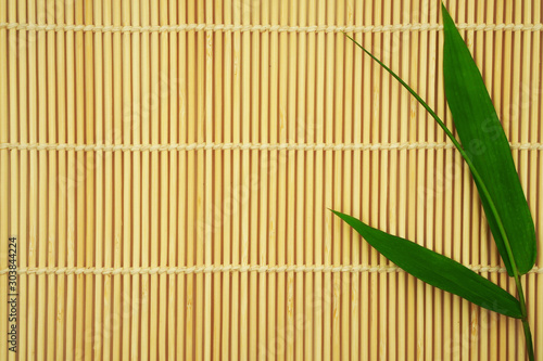 Fresh Bamboo leaves on bamboo mat or sheet for background  japanese and zen concept