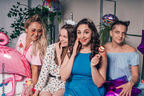 Young beautiful girls on a bachelorette party before the wedding are photographed for memory