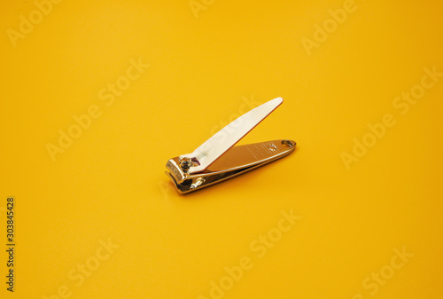 White Nail clipper or Nail cutter on yellow background photo