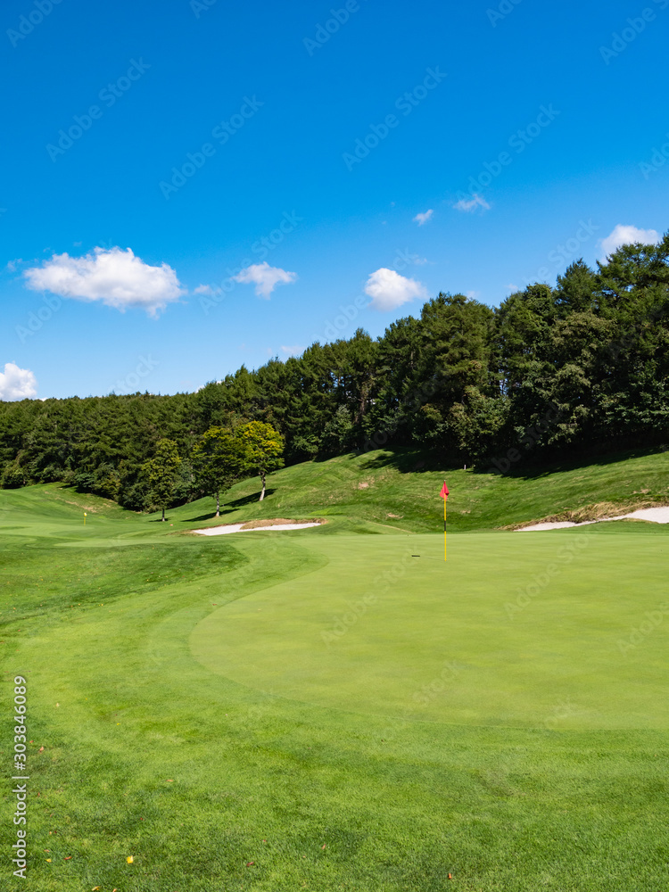 Golf Course with beautiful putting green. Golf course with a rich green turf beautiful scenery.