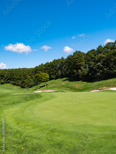 Golf Course with beautiful putting green. Golf course with a rich green turf beautiful scenery.