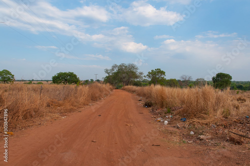 urban dirt road full of trash