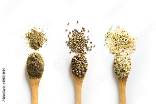 Organic dried hemp seeds, flour, kernels in wooden spoon on white background. View from above. photo