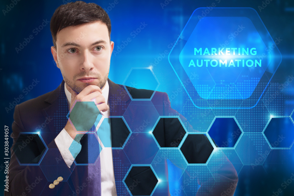 Business, Technology, Internet and network concept. Young businessman working on a virtual screen of the future and sees the inscription: Marketing automation Business, Technology, Internet and network concept. Young businessman working on a virtual screen of the future and sees the inscription: Marketing automation