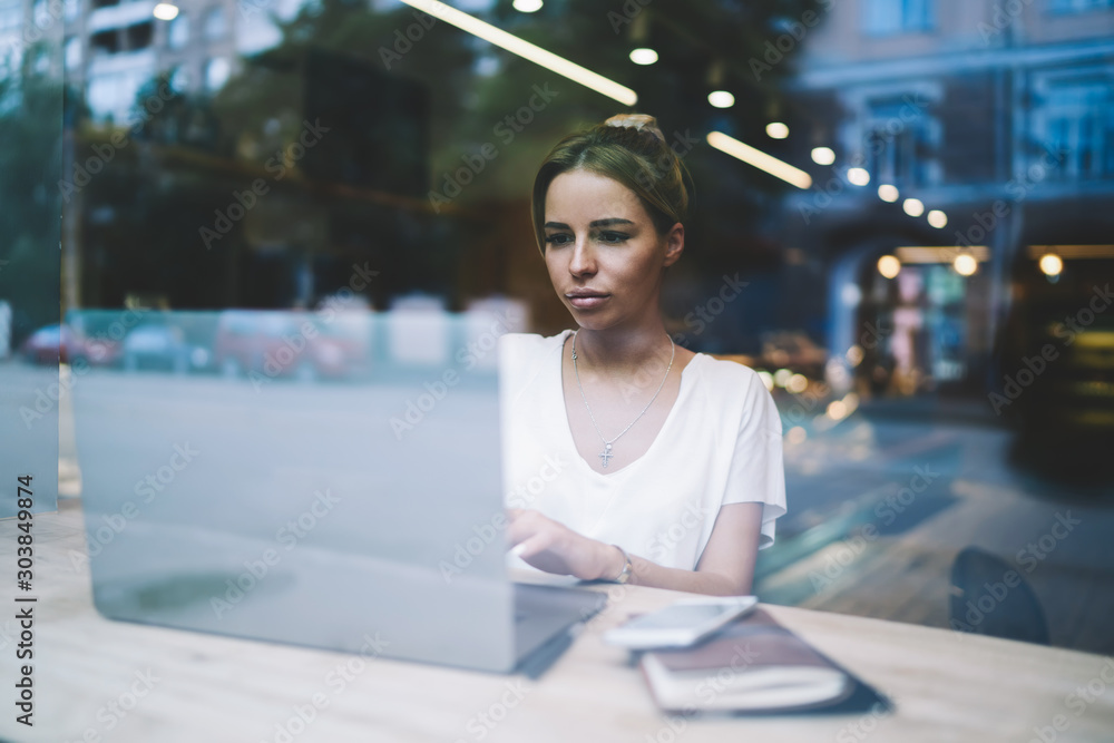 Serious woman concentrated on online webinar about languages for programming on laptop device, caucasian female copywriter reading new material on content website for next articles via modern netbook