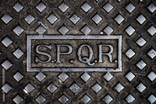 text SPQR in a cast iron manhole cover in Rome photo