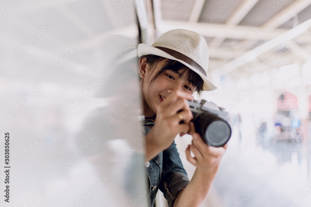Smiles happily of young woman travels by train. takes pictures of nature on the out train window on the Train. copy space,,travel, backpack concept Smiles happily of young woman travels by train. takes pictures of nature on the out train window on the Train. copy space,,travel, backpack concept