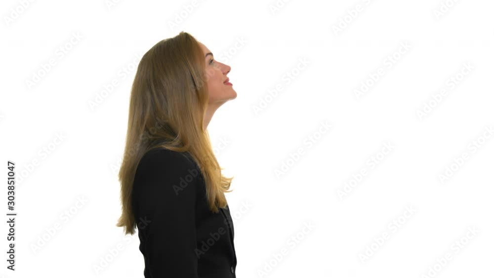 A smiling business woman is looking up at copy space. A smiling business woman is looking up at copy space.