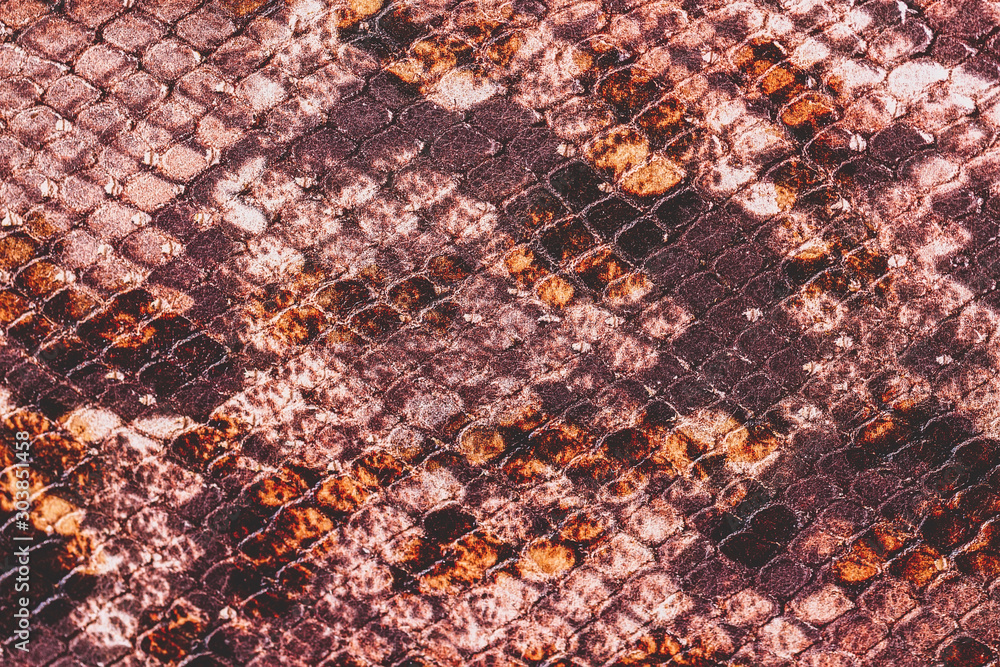 Naklejka premium Texture of genuine matte rough leather close-up, imitation of the skin of scaly exotic reptile, fashion burgundy brown color, modern background