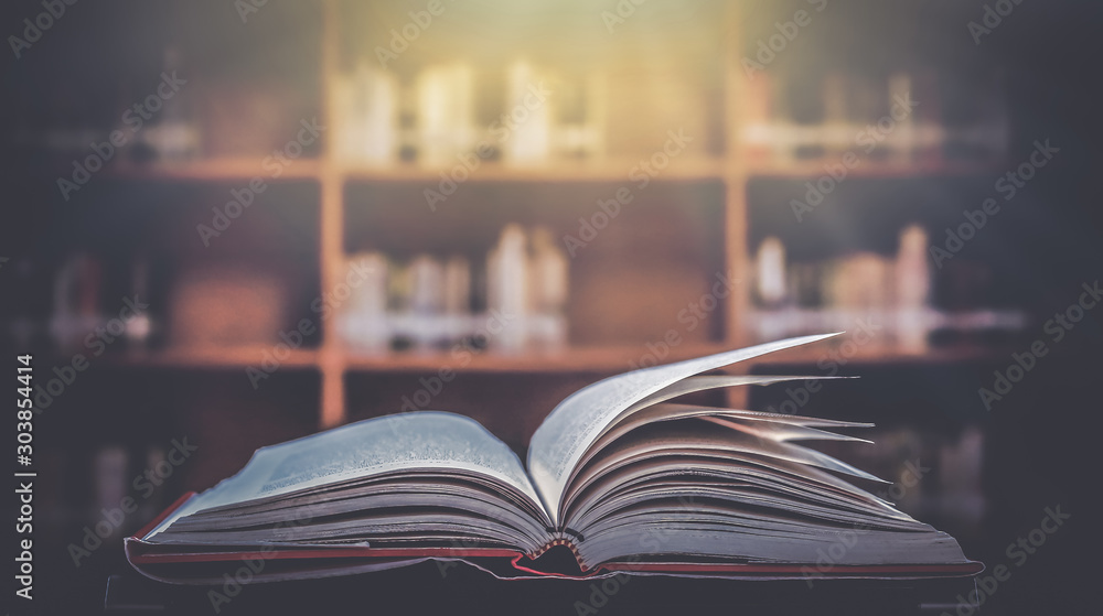 The blurred book that is bewitched with magic, the magic light in the dark, with the bright light shining down as the power to search for knowledge. For research and use as a blurred background The blurred book that is bewitched with magic, the magic light in the dark, with the bright light shining down as the power to search for knowledge. For research and use as a blurred background