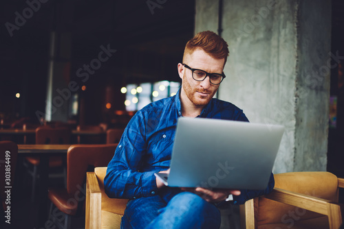 Fotografie Serious businessman searching information for organisation meeting event with pa
