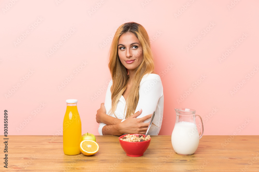 Young blonde woman having breakfast milk laughing Young blonde woman having breakfast milk laughing