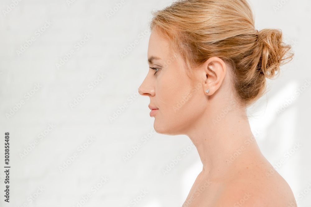 side view of attractive and naked woman looking away side view of attractive and naked woman looking away