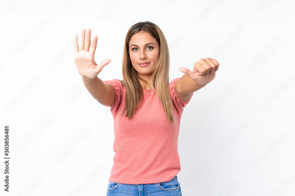 Young blonde woman over isolated white background counting six with fingers Young blonde woman over isolated white background counting six with fingers