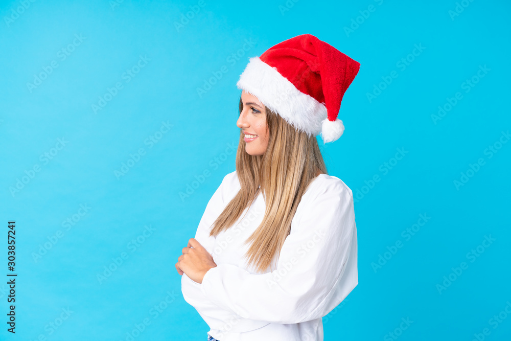 Girl with christmas hat over isolated background looking to the side Girl with christmas hat over isolated background looking to the side