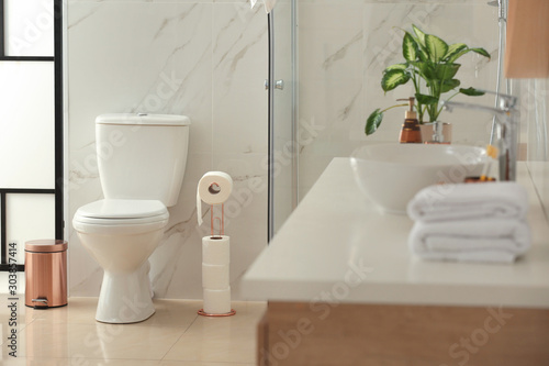 Interior of modern bathroom with toilet bowl