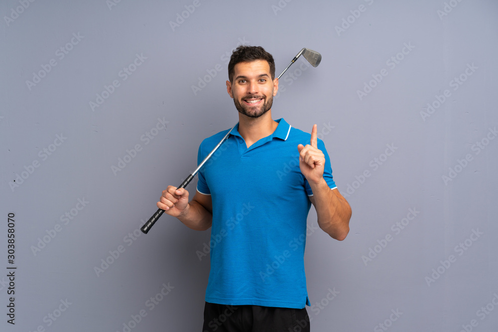 Handsome young man playing golf pointing up a great idea Handsome young man playing golf pointing up a great idea
