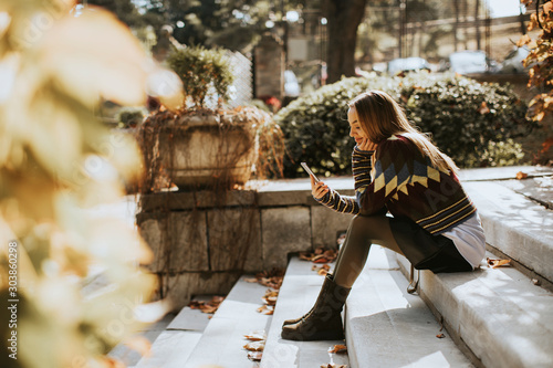 Young woman sitting on a st...