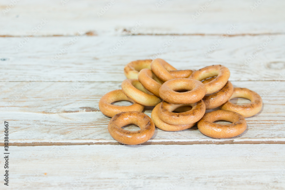 Fresh bagels (bagels) on a light wooden background. Bakery products. Fresh bagels (bagels) on a light wooden background. Bakery products.