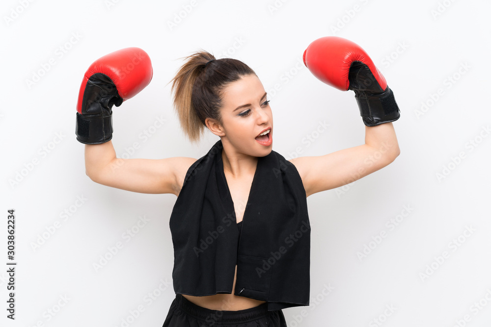 Young sport woman over white wall with boxing gloves Young sport woman over white wall with boxing gloves