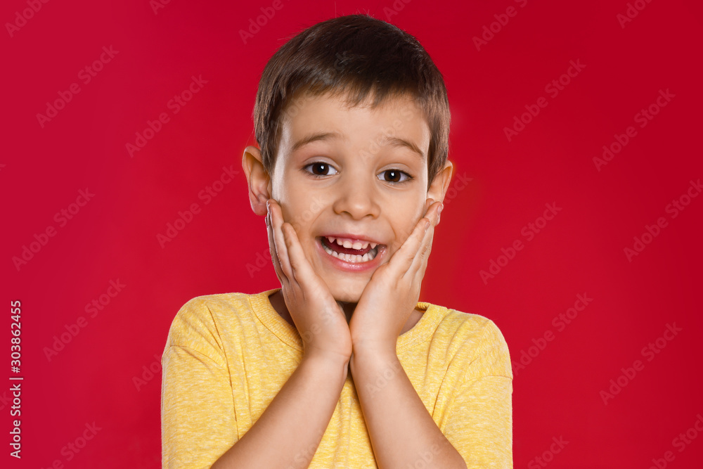 Portrait of emotional little boy on red background Portrait of emotional little boy on red background