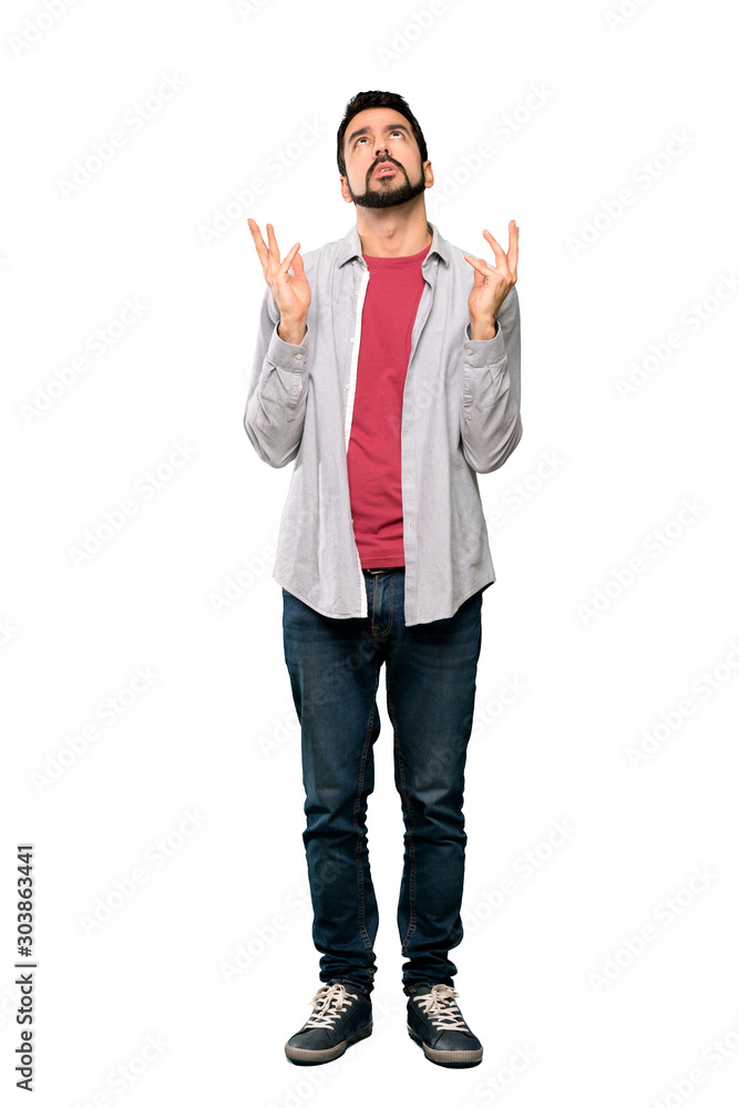 Full-length shot of Handsome man with beard frustrated by a bad situation over isolated white background Full-length shot of Handsome man with beard frustrated by a bad situation over isolated white background