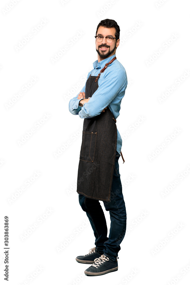 Full-length shot of Man with apron with arms crossed and looking forward over isolated white background