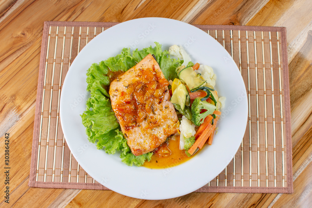 Salmon fillet in citrus sauce, fried plantain and vegetables Salmon fillet in citrus sauce, fried plantain and vegetables