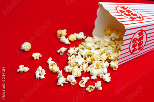 Popcorn in a classic popcorn box on a natural black background.