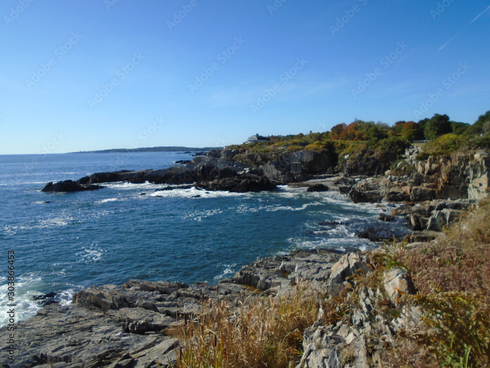 Rocky Maine Coast with the Atlantic Ocean reflecting off the water as it washes ashore