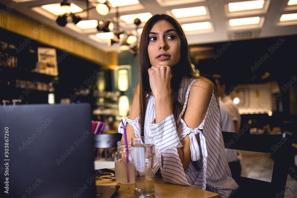 Young lady using laptop in coffee restaurant Young lady using laptop in coffee restaurant