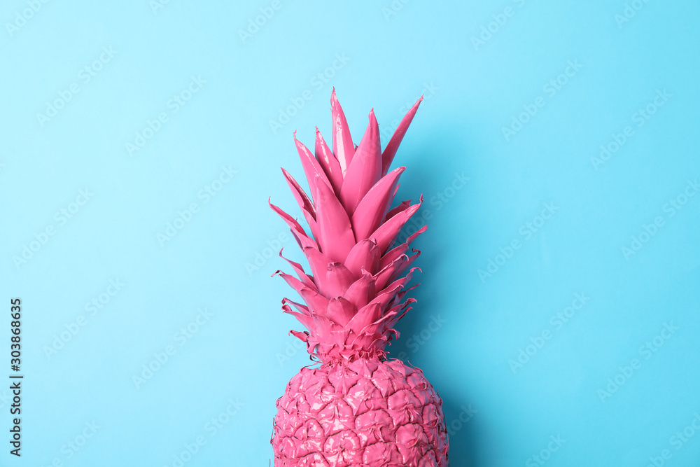 Fototapeta Painted pink pineapple on blue background, space for text
