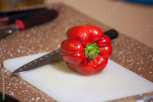  fresh juicy red sweet organic peppers on a cutting board, cooking veggie food