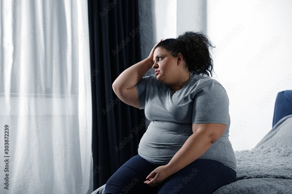 Ταπετσαρία Depressed overweight woman on bed at home