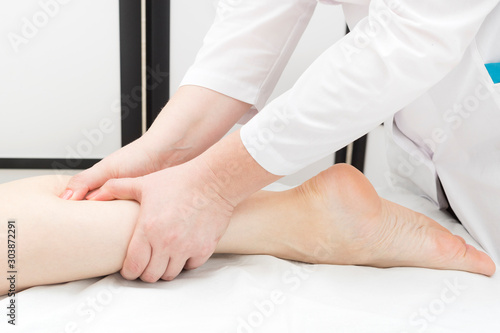 Technique of sports and wellness foot massage. Close-up shot in a beauty salon.