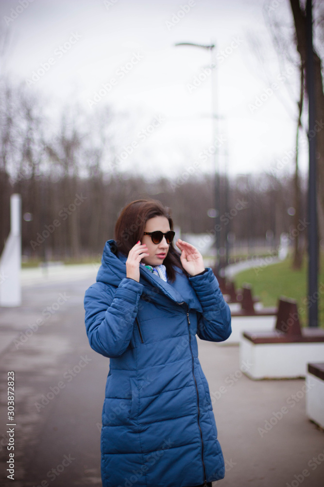 young girl in a blue jacket with glasses