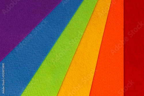 Abstract geometric pattern created with crafting felt in the LGBT rainbow flag colors of red, orange, yellow, green, blue and purple 