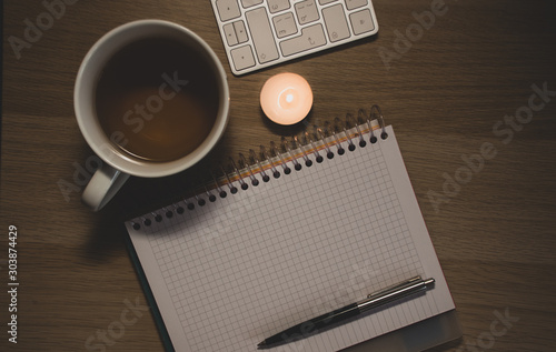 notebook and cup on wooden table
