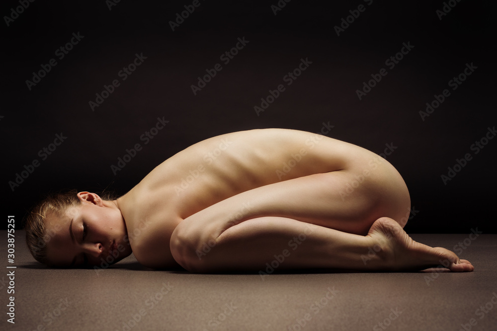 Athletic natural woman body on dark background. Nude woman Yoga. Stock  Photo | Adobe Stock