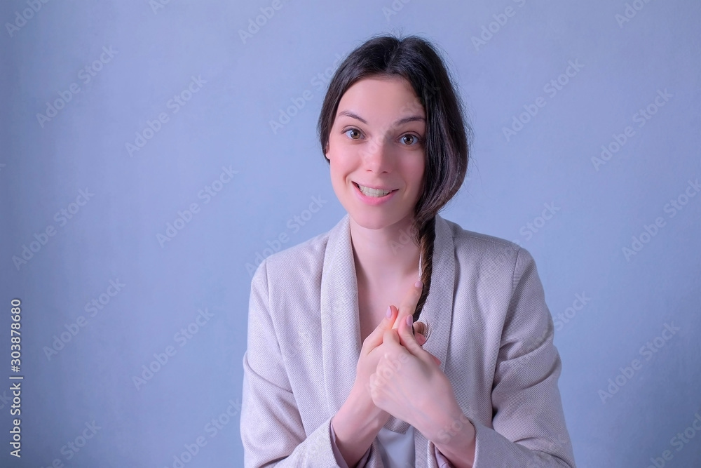 Beauty blogger talking about hairs care and problems recording video looking at camera. Young woman freelancer bloffer vlogger working. Portrait of girl on grey background. Beauty blogger talking about hairs care and problems recording video looking at camera. Young woman freelancer bloffer vlogger working. Portrait of girl on grey background.