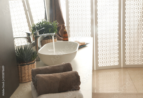 Modern bathroom interior with stylish mirror and vessel sink