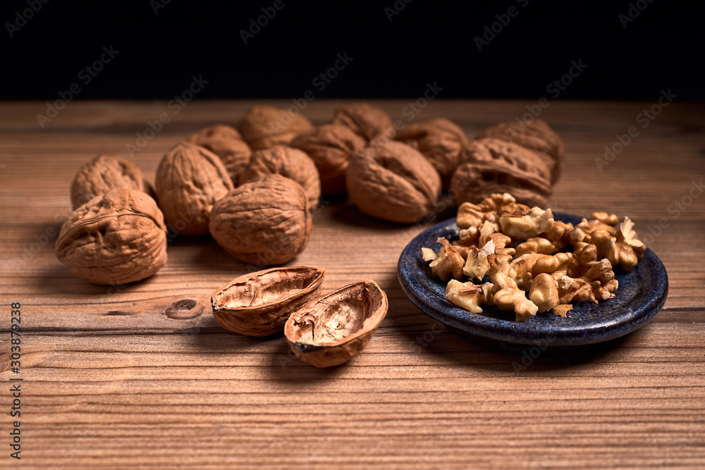 group of tasty nuts next to a bowl group of tasty nuts next to a bowl