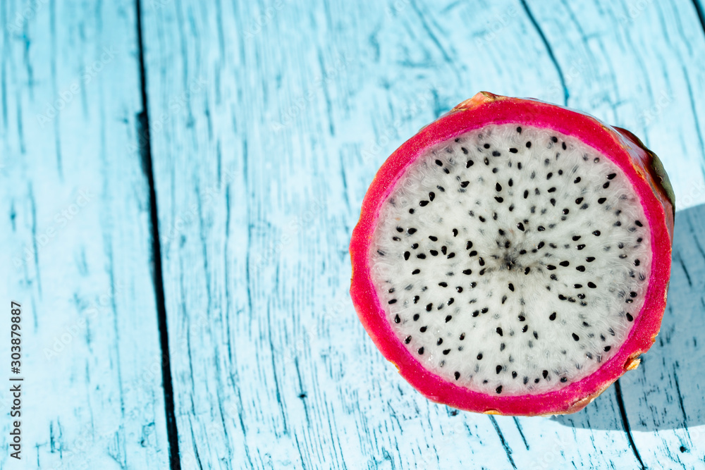 fruit dragon fruit on a blue wooden table, copy space fruit dragon fruit on a blue wooden table, copy space