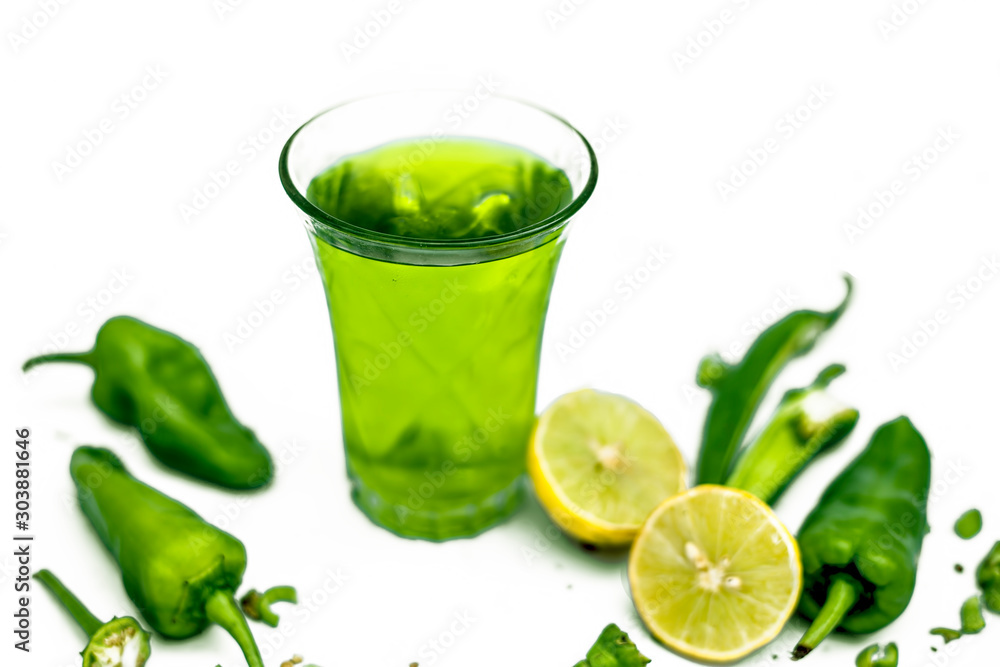 Φωτογραφία Close up shot of raw cut chilies with some sliced lemons isolated on white along with its chili flavored drink with it in a glass