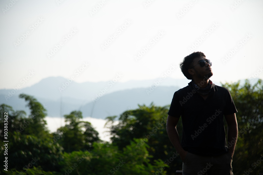 Fototapeta premium determined man, explorer pathfinder forest, military man forest, man with tactical gear at the cliff with mountain view, cool guy forest.