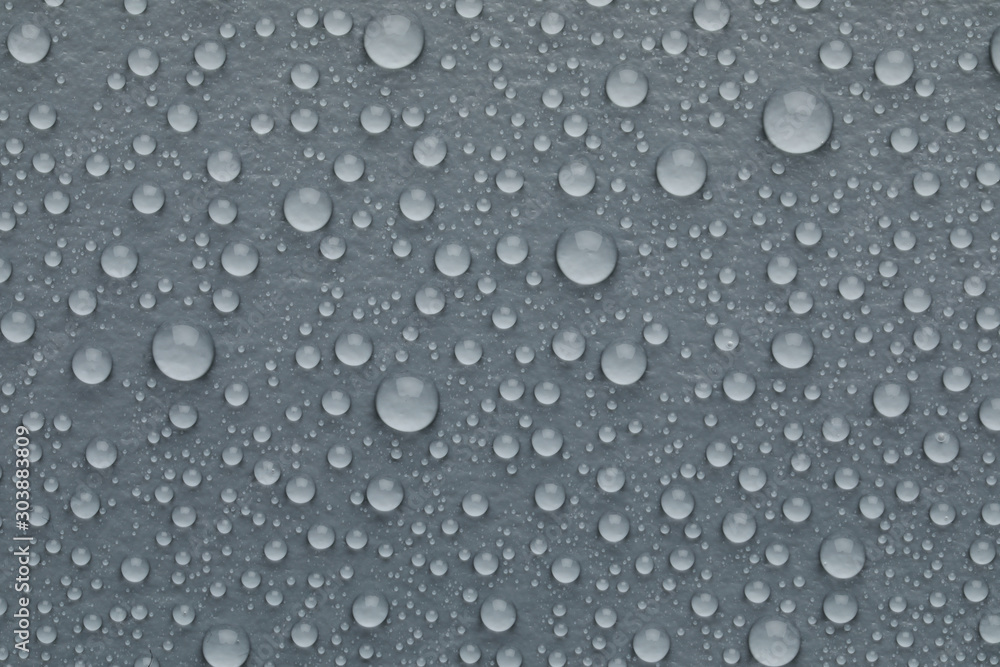 Water drops on grey background, top view
